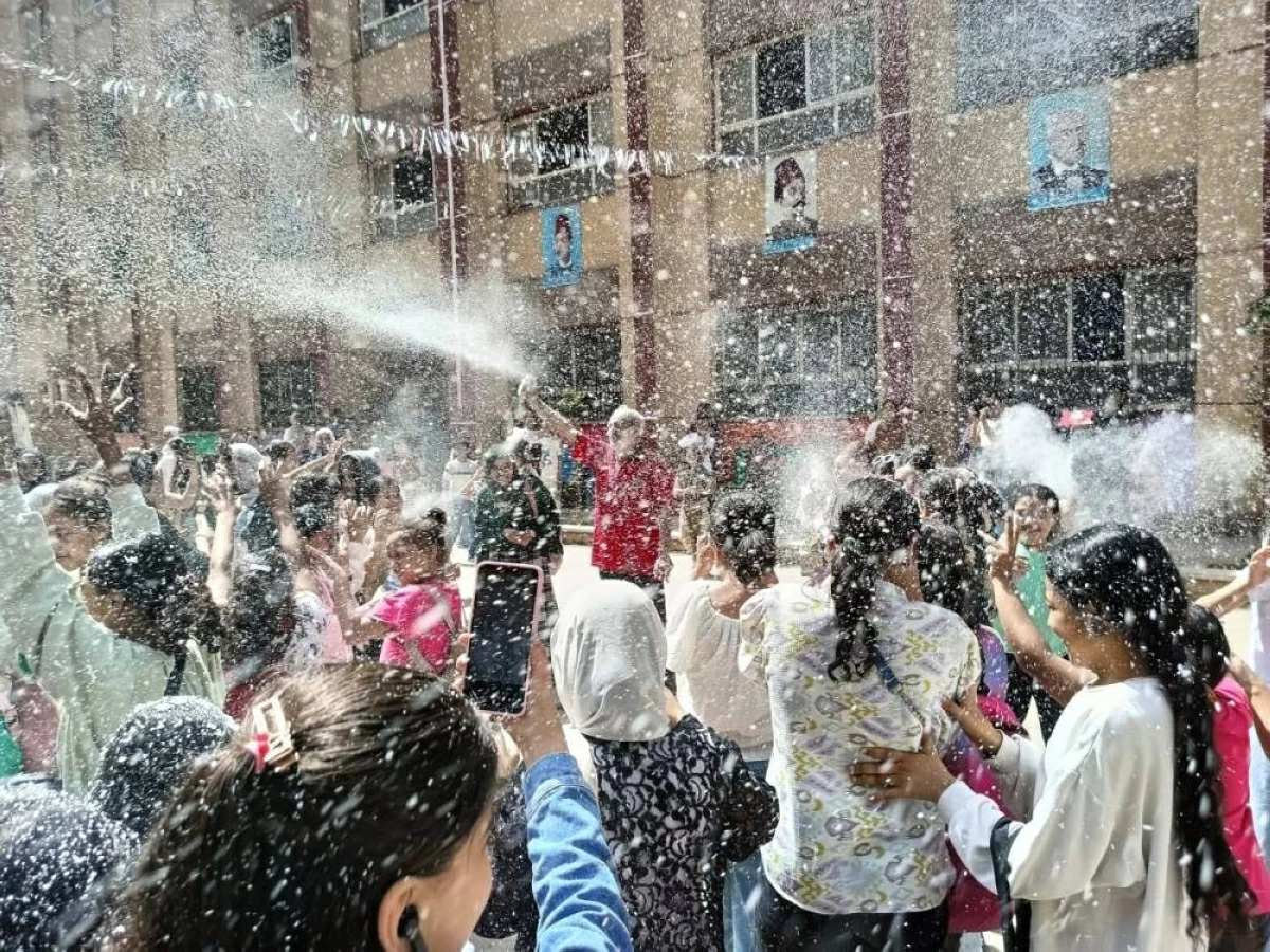 مدير المدرسة يحتفل مع الطلاب باستخدام بخاخ الثلج